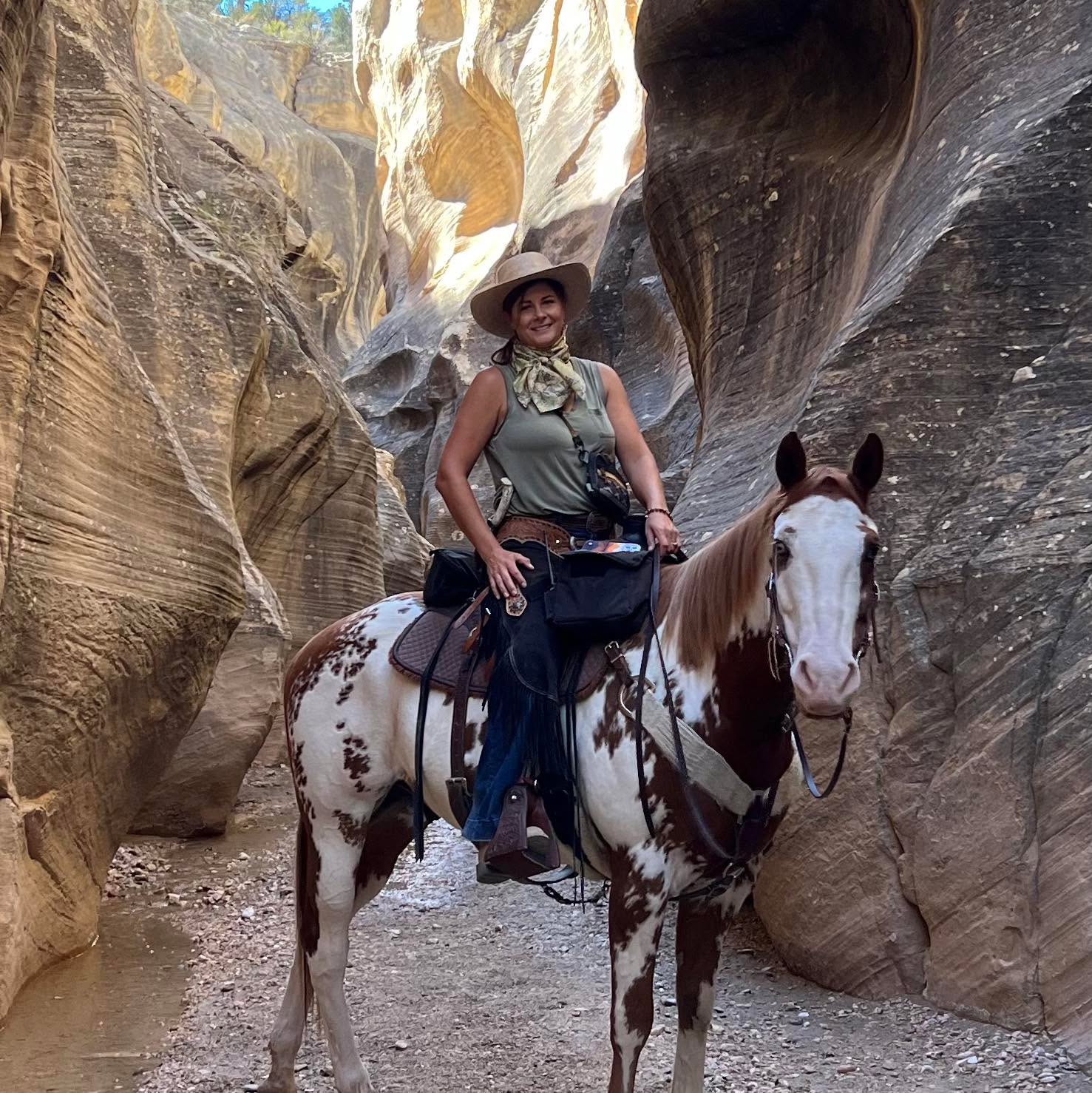Horseback riding through a sandstone canyon